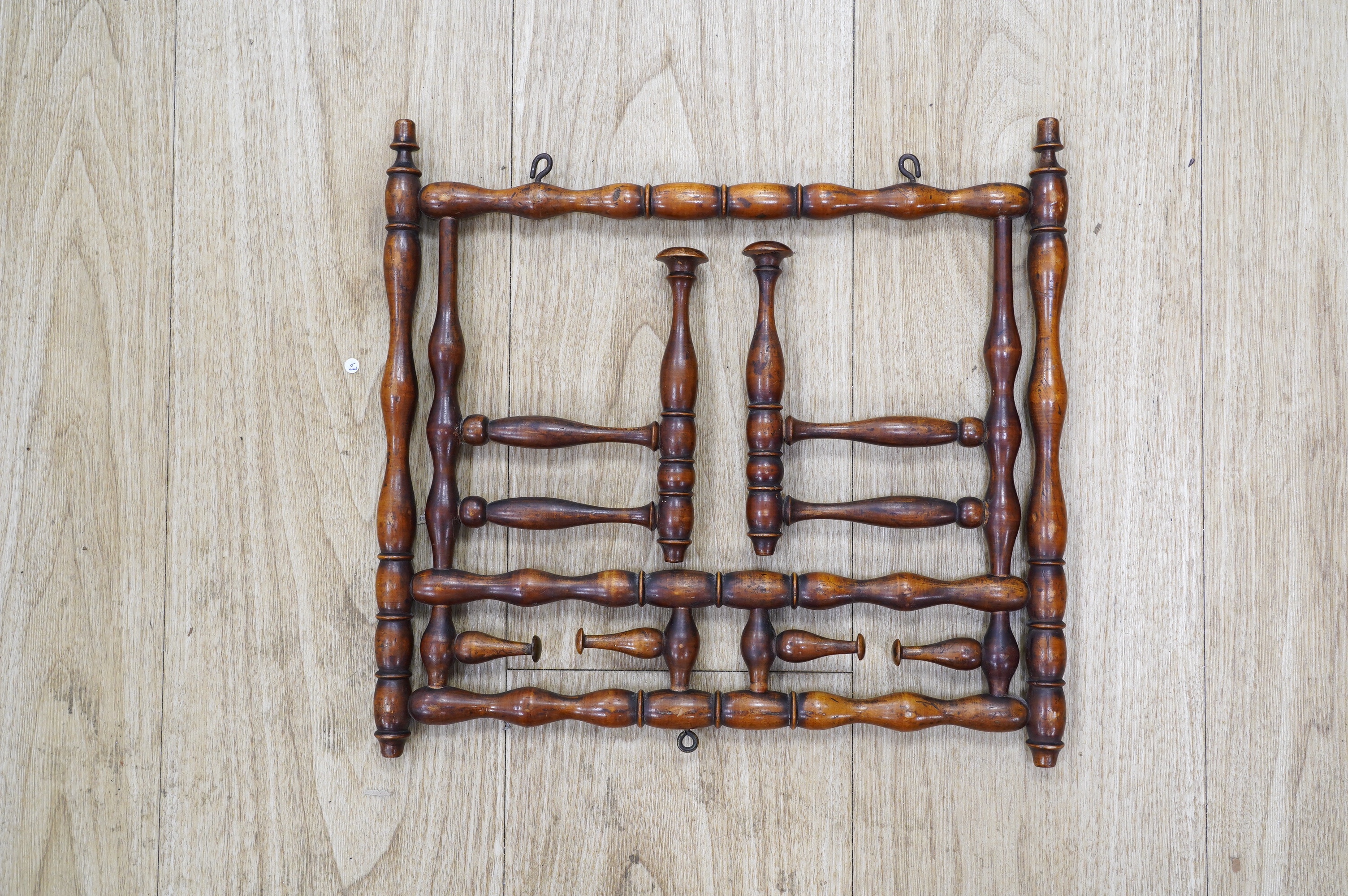 A late 19th century turned wood folding wig stand, 35cm wide. Condition - good